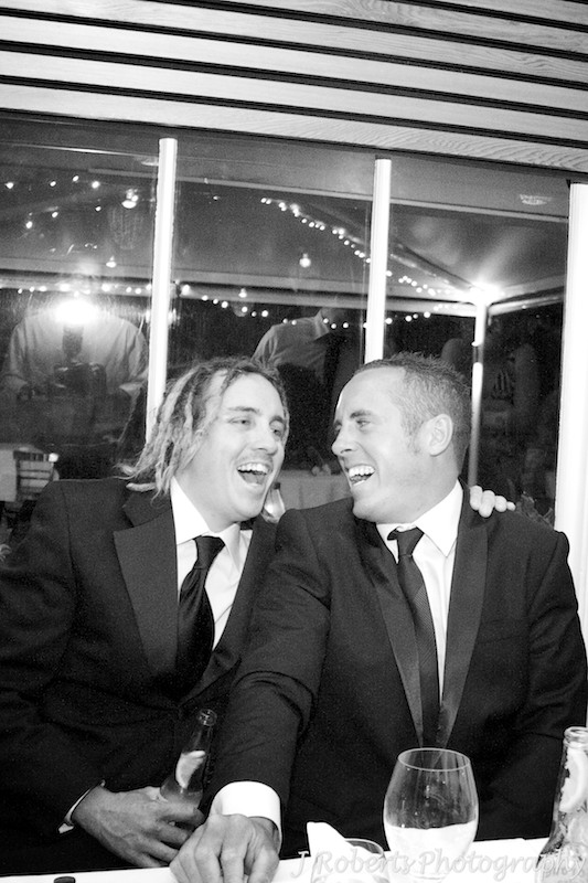 Laughing groom and best man during wedding speeches - wedding photography sydney